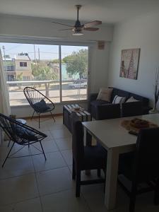 a living room with a couch and a table and chairs at Colina Dom in Victoria