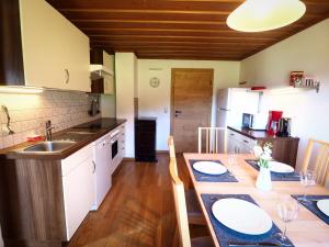 a kitchen with a table and a dining room at Appartement Herzogbauer in Saalfelden am Steinernen Meer