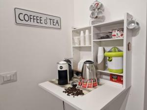 a kitchen with a cupboard with coffee and tea at Saint Peter Vatican City confortable Apartament Stellasia casa vacanza in Rome