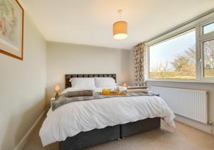 a bedroom with a large bed and a window at Journeys End in Ringstead