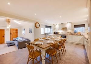 a kitchen and dining room with a table and chairs at Eva Cottage in West Runton