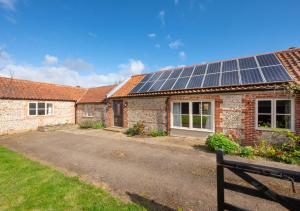 a house with solar panels on the roof at Mill Farm Barn in Walcott
