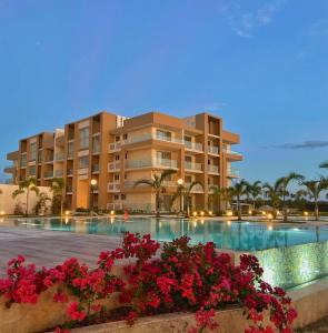 a resort with a swimming pool and some flowers at Beach front and golf paradise. Playa Nueva Romana in San Pedro de Macorís
