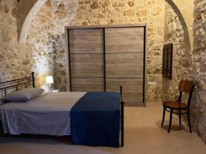 a bedroom with a bed and a large window at Brooklyn Farmhouse in Żebbuġ