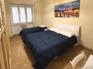 A bed or beds in a room at Palazzo Senesi