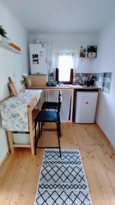 a kitchen with a table and a chair in a room at La Casuta in Fieni +14 photos
