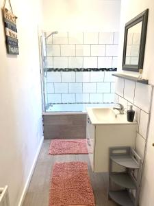 a bathroom with a sink and a bath tub at Wor Hoose in Amble