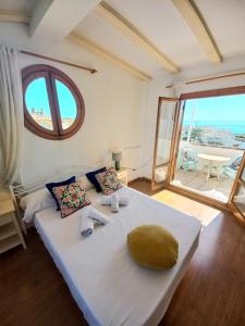 a bedroom with a large white bed with a large window at Altea Old Town Paraiso in Altea