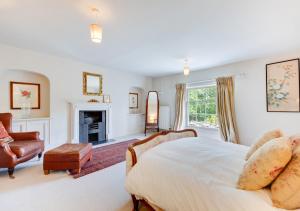 a large bedroom with a bed and a fireplace at Dilham House in Dilham