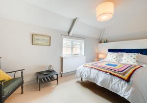 a bedroom with a bed and a window at The Hayloft in Dilham