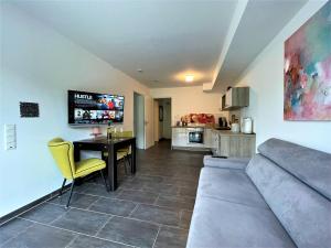 a living room with a couch and a table and a kitchen at Villa Moselufer, schönste Aussicht, Luxuriös, Netflix, Burg Cochem in Cochem