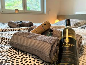 a bottle of wine sitting on top of a bed at Villa Moselufer, schönste Aussicht, Luxuriös, Netflix, Burg Cochem in Cochem