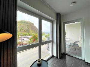 a room with a large window with a view of a mountain at Villa Moselufer, schönste Aussicht, Luxuriös, Netflix, Burg Cochem in Cochem