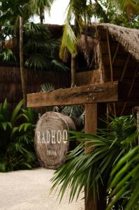 a wooden bench with a sign that says raboco at Radhoo Tulum in Tulum