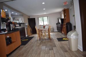 a kitchen with a table and chairs in a room at Super 8 by Wyndham La Vale/Cumberland Area in La Vale