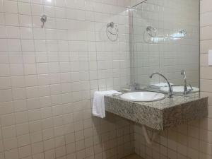a bathroom with a sink and a mirror at Arena Carneiros Hotel by AFT in Tamandaré
