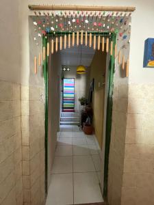a hallway with christmas lights on the ceiling and a hallway with a hallwayngth at Canto dos Artistas Olinda in Olinda