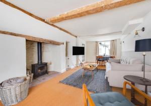 a living room with a couch and a fireplace at London Cottage in Halesworth