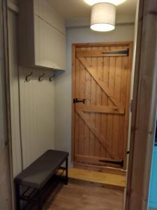 a sliding barn door in a room with a bench at self contained flat in Llanfyllin Powys in Llanfyllin