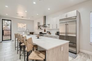 a kitchen with a large island with bar stools at Luxury 5 BDRM Home! Blocks To DT/Riverwalk/Convention Center! in San Antonio
