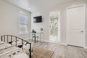 a bedroom with a bed and a table and a door at Luxury 5 BDRM Home! Blocks To DT/Riverwalk/Convention Center! in San Antonio