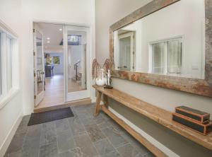 a hallway with a wooden bench and a mirror at Welcome to the Modern Mountain Luxury! home in Avon