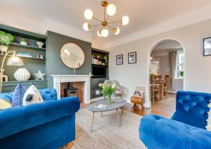 a living room with blue furniture and a fireplace at The Hideout in Beccles