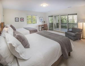 two beds in a bedroom with a balcony at Welcome to the Modern Mountain Luxury! home in Avon