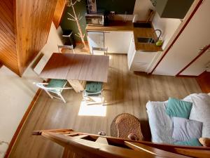 an overhead view of a living room with a table and a boat at Appartement Chalet à 1400m - Station du Mourtis in Boutx