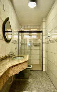 a bathroom with a sink and a toilet and a shower at Apartamento Vera in Florianópolis
