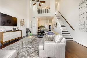 a living room with a couch and a staircase at Gorgeous 4 Bed Home on St Mary's - Minutes to Riverwalk/Pearl in San Antonio