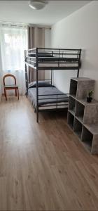 a bedroom with bunk beds and a wooden floor at V&V in Santo Stéfano Udinese