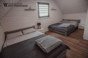 Posteľ alebo postele v izbe v ubytovaní Wisełka Park - West Pomeranian