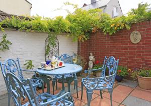 a blue table and chairs on a patio at Little Doric in Woodbridge