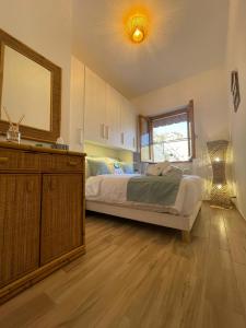 a bedroom with a bed and a mirror and a dresser at Ma. De House Lago del Turano in Valle Verde +51 photos