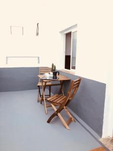 una mesa de madera y una silla en el balcón en Mar y Montaña Apartamento entero, en La Costa