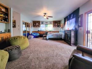 a large living room with a bed and a couch at Lunar Eclipse on 4 acres w hot tub in Yucca Valley