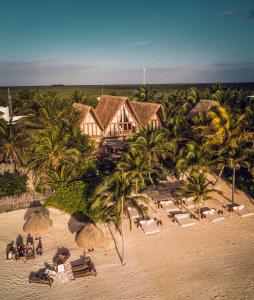 an aerial view of a resort with chairs and palm trees at La Valise Tulum in Tulum