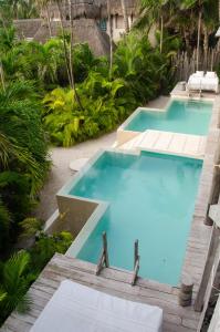 a swimming pool with blue water in a resort at La Valise Tulum in Tulum