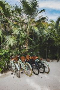 bikes parked next to each other on a beach at La Valise Tulum in Tulum