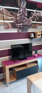 a desk with a tv on top of it at INTERNO 12 in Vercelli