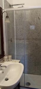 a bathroom with a sink and a glass shower at INTERNO 12 in Vercelli