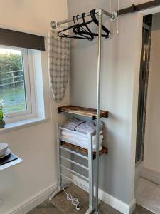 a towel rack in a room with a window at Adorable bedsit for you, partner and your pet! in Pembrokeshire