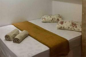 łóżko z 3 poduszkami na górze w obiekcie Lindo e aconchegante apt para até 04 pessoas w mieście Gama