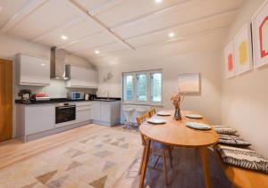 a kitchen and dining room with a table and chairs at Rose Cottage in Middleton