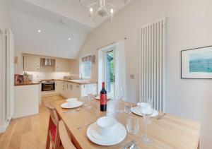 a dining room with a table with wine glasses at Woodland Lodge in Wilby