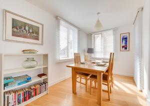 a dining room with a wooden table and chairs at Osprey in Southwold