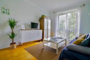 a living room with a couch and a coffee table at Apartament Dana in Kołobrzeg