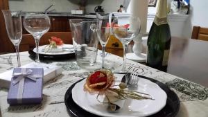 a table with two plates of food and wine glasses at Il Palazzetto dei Briganti in Guardiaregia +35 photos