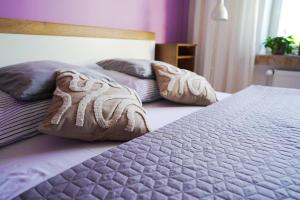 two beds with pillows on them in a bedroom at Apartament Dana in Kołobrzeg